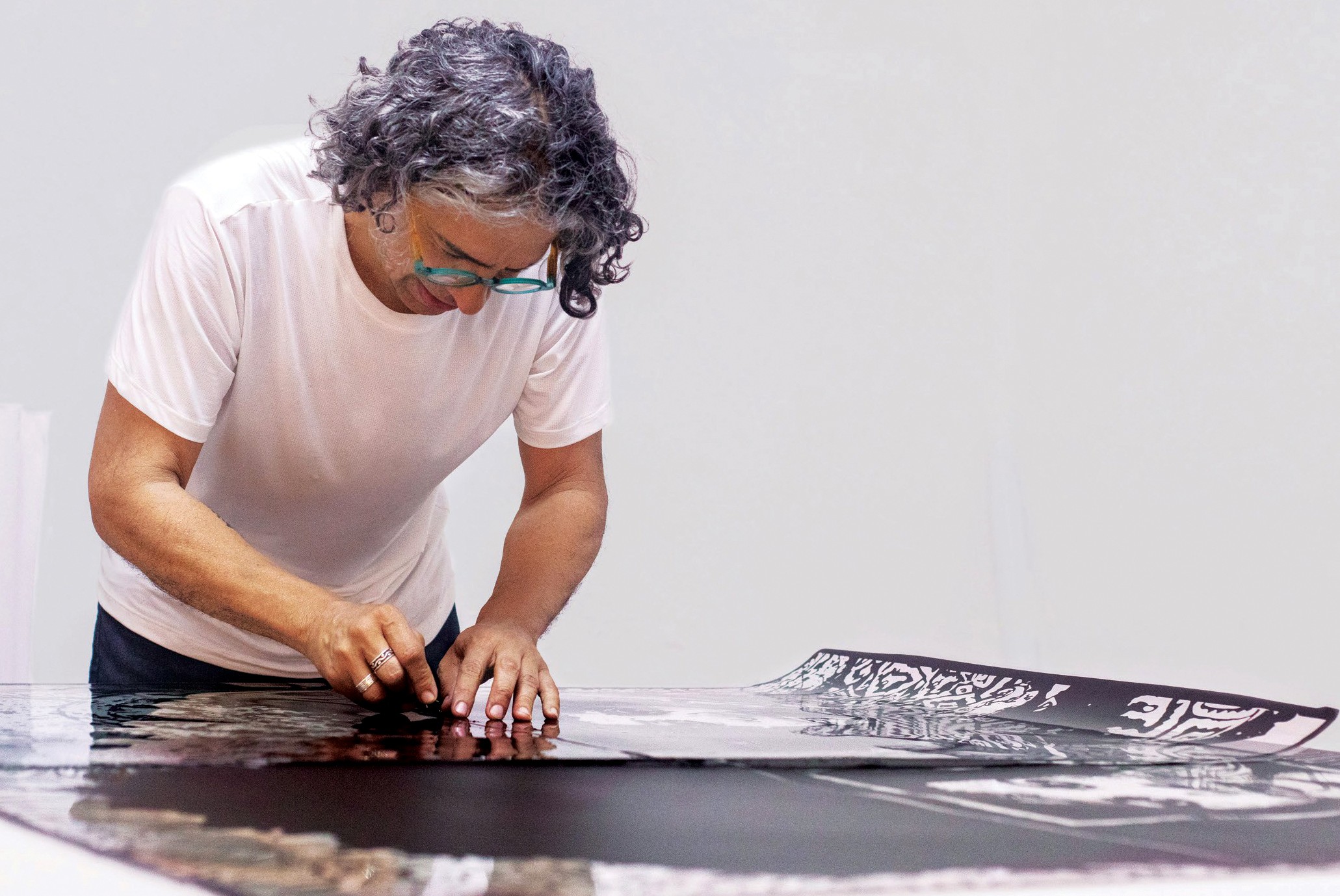Alex Guerrero pulling a screenprint at a live printing session